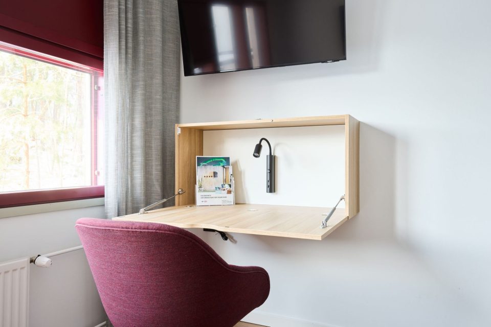 Linnasmäki single room desk Chair at the wall-mounted fold-down desk.